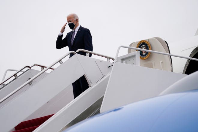 President Joe Biden salutes before boarding Air Force One for a trip to Kalamazoo, Mich., to visit a Pfizer plant, Feb. 19, 2021, in Andrews Air Force Base, Md.