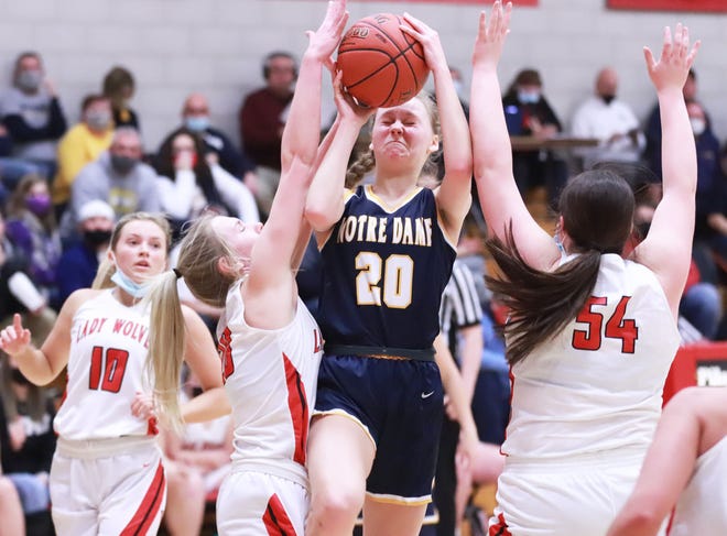 Notre Dame’s Katy Stephens takes the ball to the hoop through WMU defenders Farrah Nelson (left) and Jobey Malone (right).