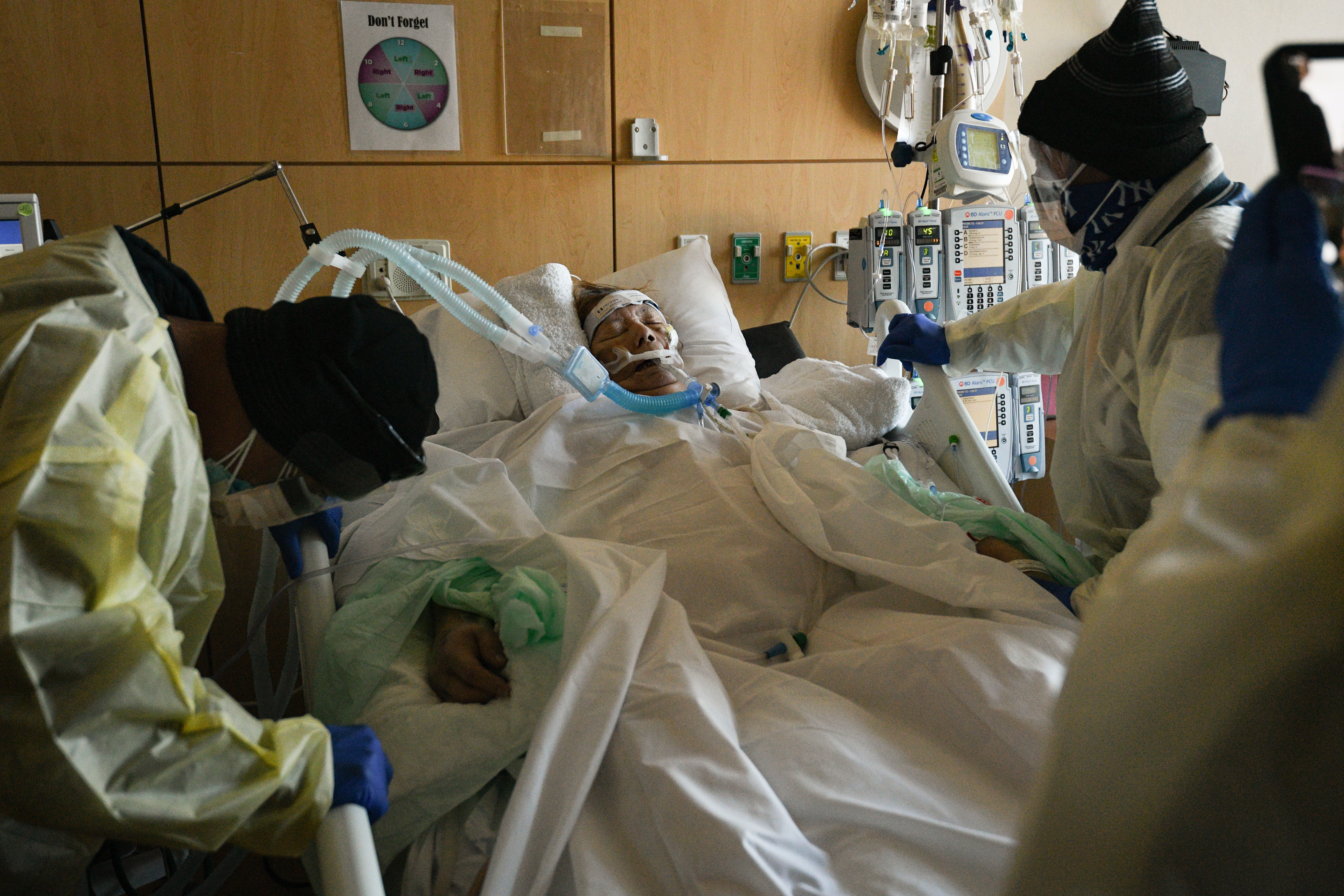 Lorenzo Dominguez Jr, 54 prays for his mother, Etelvina Dominguez, during his visit on Feb. 12 at Providence Holy Cross Medical Center in Mission Hills, California. Dominguez and his father, Lorenzo Dominguez Sr., 88, were the only family members allowed into the hospital. "I hear about it, I see it on the news. And it doesn't really hit you until it hits home," Dominguez said. Etelvina passed away the next day.