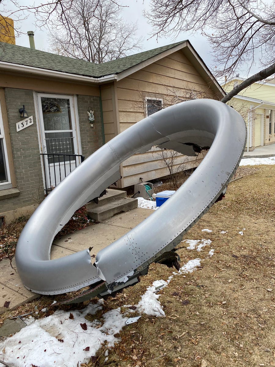 In this photo provided by the Broomfield Police Department on Twitter, debris is scattered in the front yard of a house at near 13th and Elmwood, Saturday, Feb. 20, 2021, in Broomfield, Colorado.