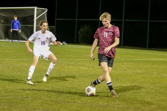 Tate's Caleb Wise (11) works the ball away from Niceville's Gavin Phillips (19) in the Region 1-6A semifinal game at Ashton Brosnaham Park on Saturday, Feb. 20, 2021.