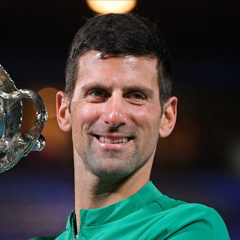 Serbia's Novak Djokovic holds the Norman Brookes C