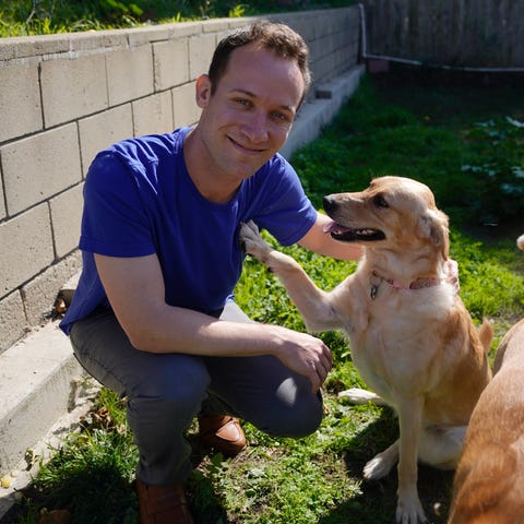 Alex Willen sits with his dog at his home in San D