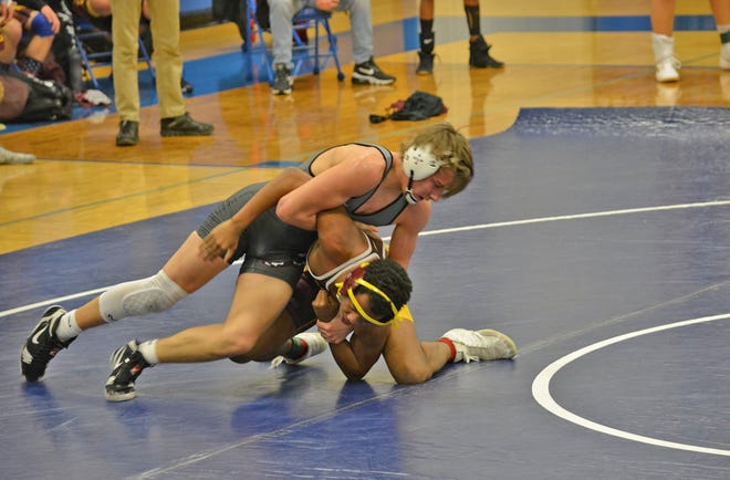 Union City's Garrett Halder takes the big steps to flip his opponent for a pin fall win Saturday.