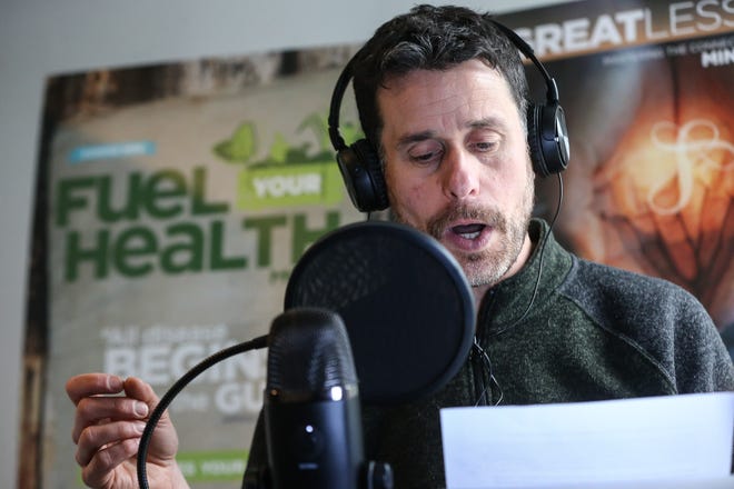 Drew Pearlman hosts a podcast at his home in Framingham, Feb. 20, 2021.