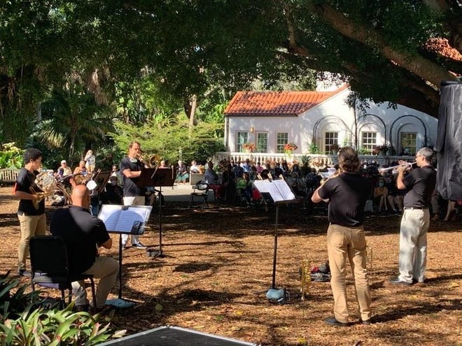 A brass ensemble from the Sarasota Orchestra performs outdoors in Selby Gardens. The open air makes it safer for brass and brass musicians to play.