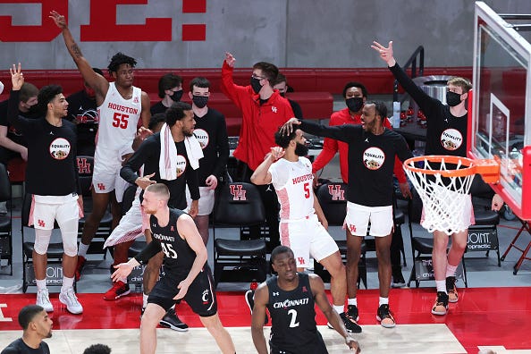 Cameron Tyson #5 of the Houston Cougars puts up a 3-point basket defended by Mason Madsen #45 of the Cincinnati Bearcats during the second half of a game at the Fertitta Center on February 21, 2021 in Houston, Texas.