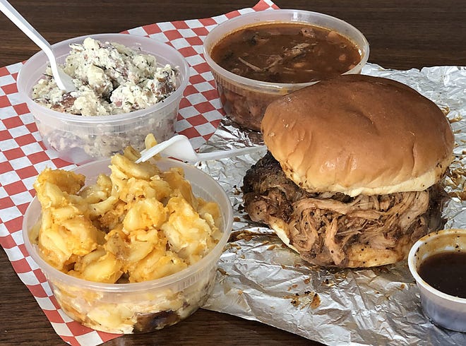 Some of the features at Joe's Barbecue in Brimfield include a pulled pork sandwich with sides of macaroni and cheese, buttermilk potato salad and charro beans.