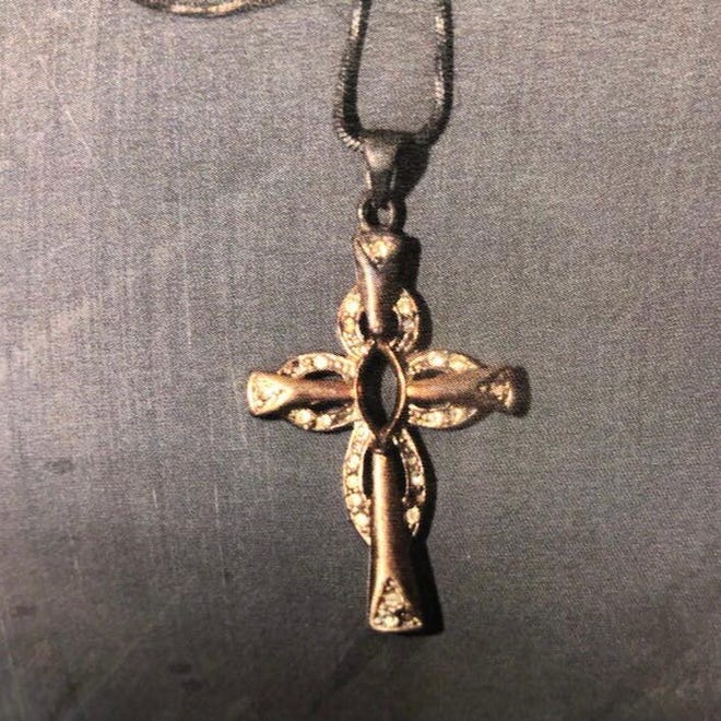 The Clay County Sheriff's Office says this gold cross was found on the woman whose body was found Monday in Black Creek.