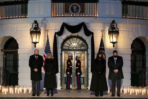 President Joe Biden, first lady Jill Biden, Vice President Kamala Harris, and Doug Emhoff bow their heads during a ceremony to honor the 500,000 Americans that died from COVID-19, at the White House, Monday, Feb. 22, 2021, in Washington.