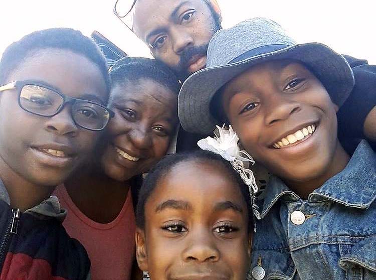 Tia Ferguson, 40, is pictured here with her husband and their three children. If they receive a third round of stimulus checks, they are both using it toward opening their own businesses.