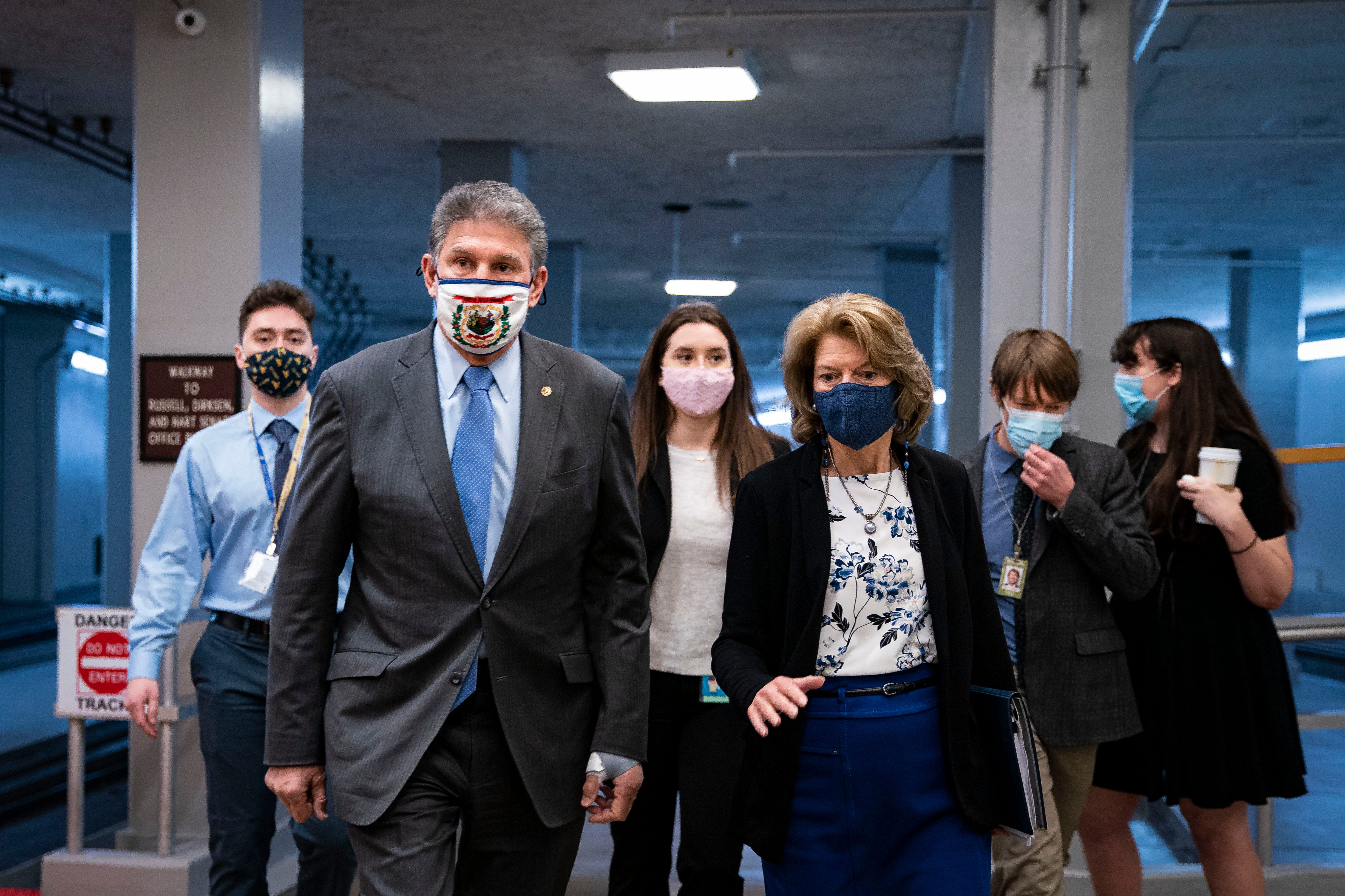 Sen. Joe Manchin, D-W.V., and Sen. Lisa Murkowski, R-Alaska, speak as they arrive to vote in the U.S. Capitol on Tuesday.