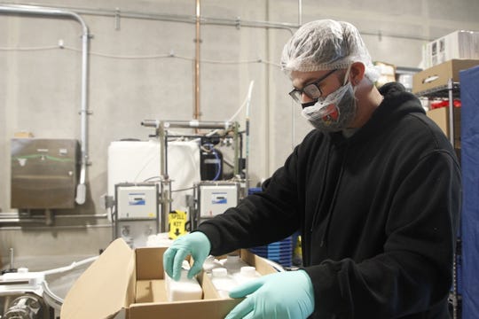 A SenesTech employee packages bottles of ContraPest, a liquid substance that makes rats infertile if they eat it. The company hopes the product can help keep rat populations under control.