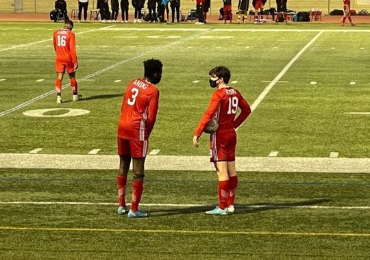 Tobi Babarinde (left) and Matthew White (right) discuss their options for the upcoming free kick for Brophy's boys soccer team, in a Feb. 19, 2021 game against Sandra Day O'Connor.