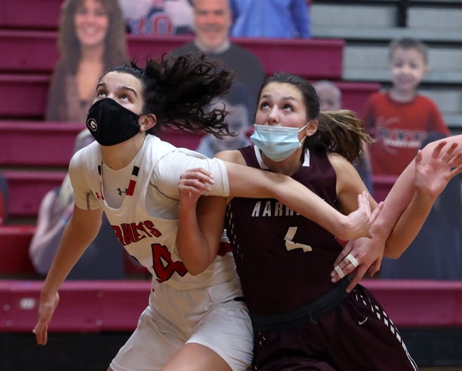 Rye's Amanda Latkany, left, fights for position under the net with Harrison's Olivia Debald during their game at Rye Feb. 23, 2021. Rye won 60-52.