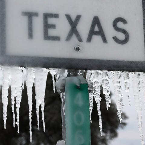Icicles hang off the  State Highway 195 sign on Fe
