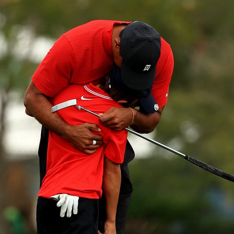 Tiger Woods hugs his son Charlie Woods at the PNC 