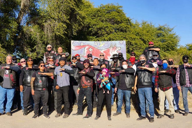 Members of Redrum Motorcycle Club stand with Wendsler Nosie and members of Apache Stronghold at Oak Flat on Feb. 21, 2021.