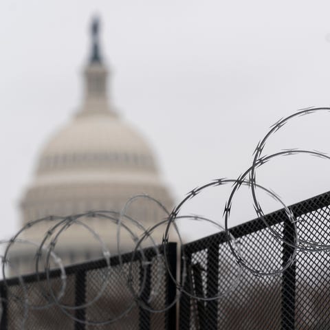 The U.S. Capitol is seen behind the razor fence ar