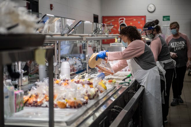Tracey Pipes, 50, organizes tortillas before serving lunch to in-person students at East Hardin Elementary School on Thursday, Feb 25, 2021 in Savannah, Tenn. Ms. Pipes has been working within the Hardin County school system since 2006. When the pandemic started she learned to juggle feeding both in-person and distance learning students. She states that it is fast pace work but they have to do it, to get it done. 