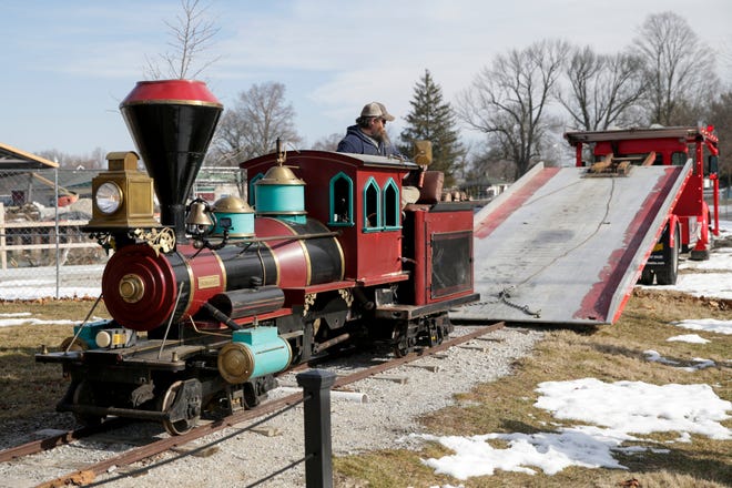Lafayette Parks and Recreation employee Todd Daugherty backs the Columbian Park Express onto a flatbed tow truck to be hauled offsite for restoration, Friday, Feb. 26, 2021 in Lafayette. The train first arrived at Columbian Park in 1968.
