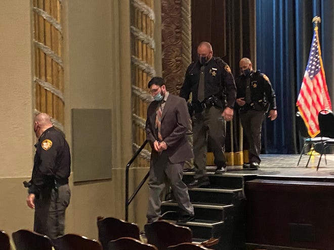 Delaney Daniels (center) is escorted by Licking County deputies out of the Midland Theatre in Newark after he was found guilty of all charges in the shooting death of Matthew Helman on Friday, Feb. 26, 2021. Daniels was sentenced to 40 years to life in prison.