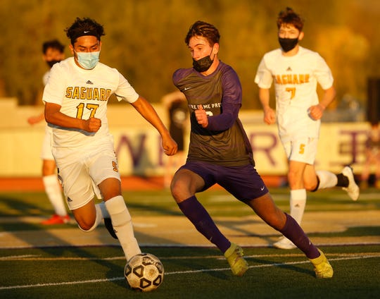 Feb. 11, 2021; Scottsdale, Arizona, USA; Notre Dame Prep's Riley McMenomy (16) dribbles up the pitch against Saguaro's Hector Hernandez (17) during the first half at Notre Dame Prep. Mandatory Credit: Patrick Breen-Arizona Republic
