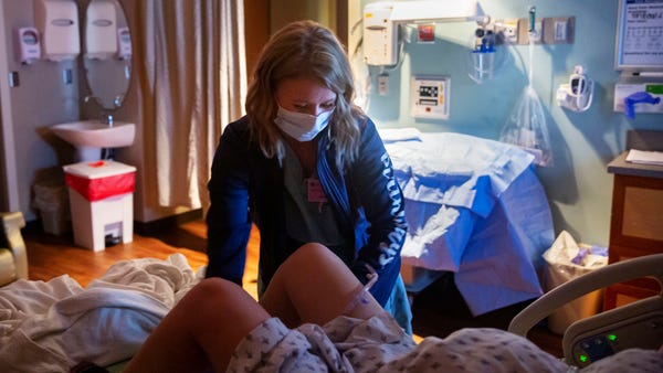 Birthways Nurse Cherish Shuka helps a mother in la