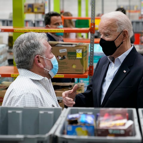 President Joe Biden talks with a volunteer at the 