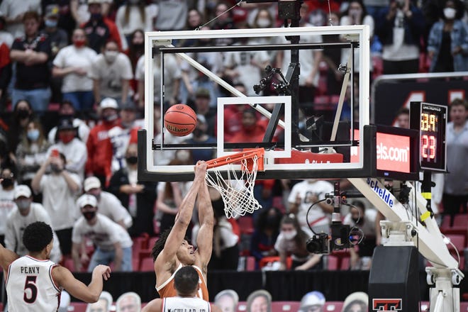 Texas' Jericho Sims (20) misses a dunk during the second half of an NCAA college basketball game against Texas Tech in Lubbock, Texas, Saturday, Feb. 27, 2021. (AP Photo/Justin Rex)