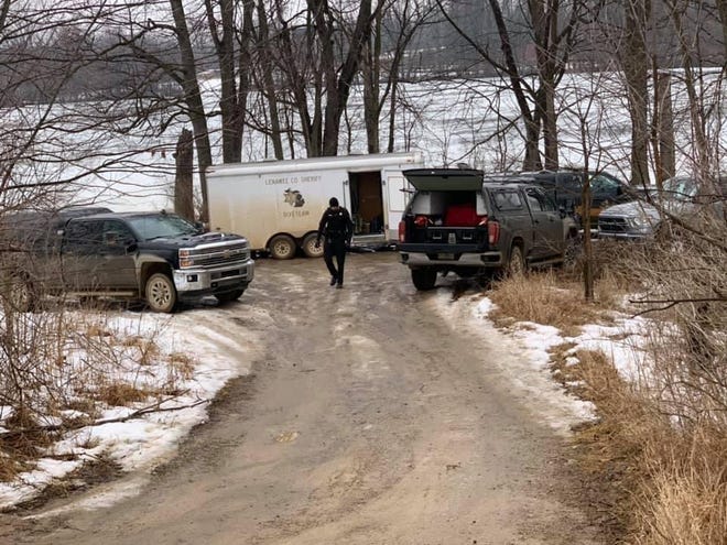 Divers from the Lenawee County Sheriff’s Office and Michigan State Police gear up Saturday at the Durfee Lake public access to continue the search for a man, presumed drowned.