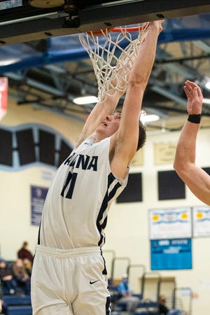 Adena senior Logan Bennett hangs off the rim after dunking the ball during a Division III sectional final game against Meigs in Frankfort, Ohio, on Feb. 26, 2021. Bennett scored 25 points for the night to help Adena defeat Meigs 75-52.