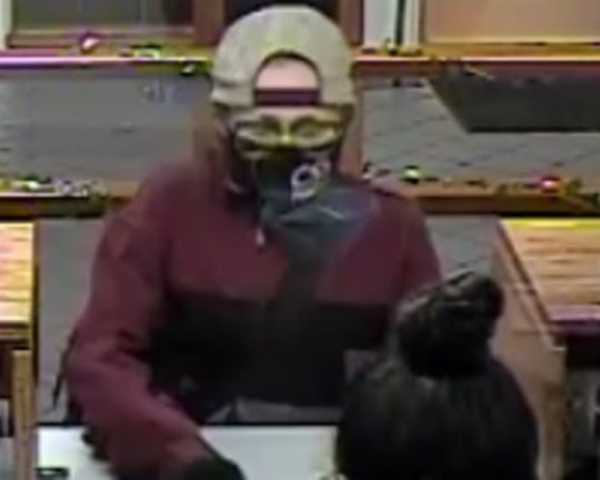 This is a surveillance photo of a serial bank robber dubbed the 'Piggy Bank Bandit' who is suspected of robbing two banks in Phoenix on Friday, Feb. 26, 2021, in addition to four other banks and credit unions since December 2020.