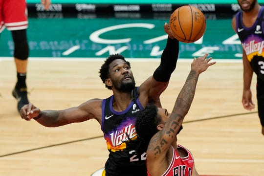 Phoenix Suns center Deandre Ayton, left, blocks a shot by Chicago Bulls guard Coby White during the second half of an NBA basketball game in Chicago, Friday, Feb. 26, 2021. (AP Photo/Nam Y. Huh).