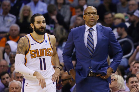 Phoenix Suns head coach Monty Williams, right, talks with Suns guard Ricky Rubio (11) during the first half of an NBA basketball against the Philadelphia 76ers game Monday, Nov. 4, 2019, in Phoenix. (AP Photo/Ross D. Franklin)