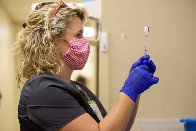 Maury Regional Medical Center Pharmacist Courtney Goodman prepares a syringe with the vaccination for the COVID-19 virus during a distribution event for Maury County Public Schools on Friday, Feb. 26, 2021.