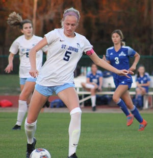 St. Johns Country Day midfielder Paige Crews (5) prepares to pass during a state girls soccer semifinal against Geneva.