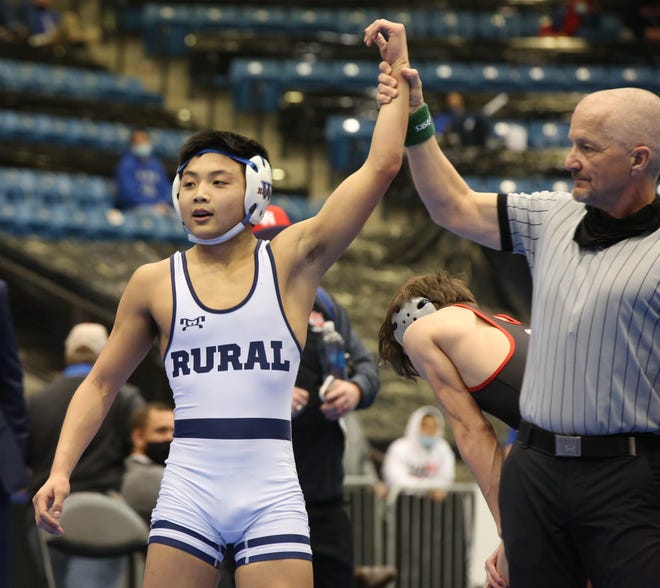 Washburn Rural's Jacob Tangpricha has his hand raised as a state champion for the second straight year after winning the 113-pound title Saturday at the Class 6A state championships at Hartman Arena. Tangpricha took a 3-1 win in the finals against Olathe North's Cael Alderman.