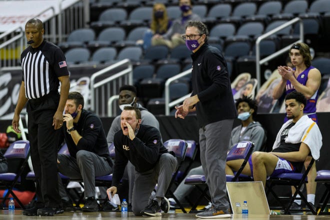 University of Evansville assistant Logan Baumann (center) yells to the Purple Aces on the court as the Aces defeated Missouri State 72-63 on Feb. 27 at Ford Center.