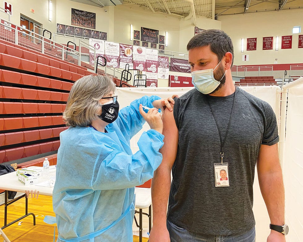 Holly Cross, Oak Ridge Schools/Special to The Oak Ridger
Lori Gupton, Oak Ridge High School's nurse, vaccinates James Mitchell, of Jefferson Middle School, on Friday, February 26, 2021, at the high school during a vaccination clinic for all employees in the school system. In an online meeting with the Tennessee Press Association Monday, Gov. Bill Lee said 60,000 Tennesseans were vaccinated for COVID-19 last Friday.
