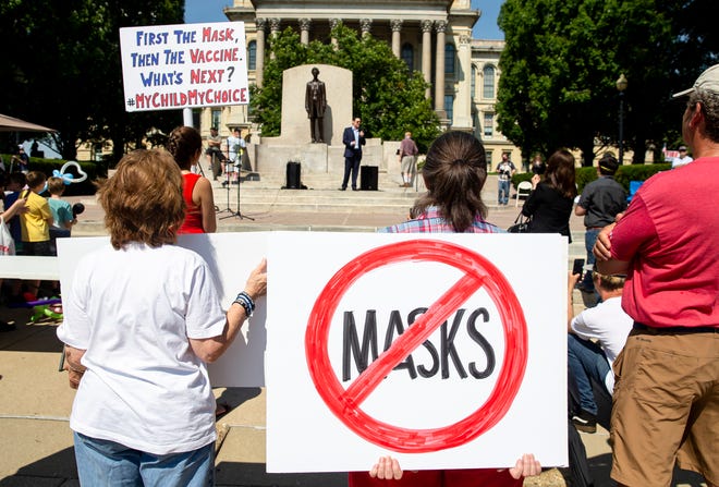 Protesters listen to William Kelly, host of the Citizen Kelly Show, as he speaks about suing Gov. JB Pritzker over COVID-19 restrictions during the Million Unmasked March at the Illinois State Capitol, Saturday, July 25, 2020, in Springfield, Ill. The protesters gathered in front of the Abraham Lincoln Statue to voice their opposition to guidelines that children be required to wear face masks when they return to school during the COVID-19 pandemic. [Justin L. Fowler/The State Journal-Register] 