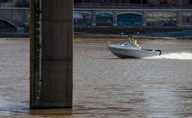 A speedboat passes under the Roebling Bridge on Monday, March 1, 2021. According to the National Weather Service the Ohio River reached a depth of 48.34 feet on Tuesday and is predicting the river will rise to a depth of 54.5 feet by Thursday, March 4th. 