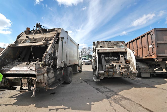 Garbage trucks sit outside the Department of Public Works (DPW) Solid Waste Garage Thursday, Feb. 25, 2021 at 2567 S. Belmont Avenue.