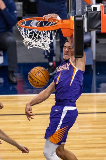Feb 28, 2021; Minneapolis, Minnesota, USA; Phoenix Suns guard Devin Booker (1) drives to the basket and dunks the ball in the first half against the Minnesota Timberwolves at Target Center. Mandatory Credit: Jesse Johnson-USA TODAY Sports