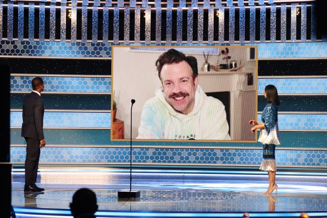 Jason Sudeikis accepts the Best Television Actor – Musical/Comedy Series award for ‘Ted Lasso’ via video from Sterling K. Brown (left) and Susan Kelechi Watson (right)  at the 78th Annual Golden Globe Awards held at the Beverly Hilton Hotel.