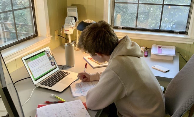 Davis Bearden, a senior at Westlake High School, learns virtually.  Laptops make it harder to have good posture because you often are looking down on them and are hunched over.
