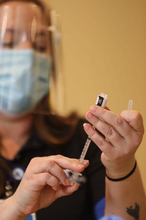 Jen Howe, a registered nurse at Great River Health, fills a syringe with a dose of a COVID-19 vaccine Feb. 10 during a Des Moines County Public Health Department COVID-19 vaccination clinic at the Burlington Memorial Auditorium. Tuesday's clinic was evacuated due to a nearby main gas line leak.