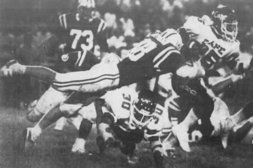 An unidentified Wyoming player applies a flying tackle to CAPE running back Carlos Snow in the Sept. 20, 1985, Cincinnati Hills League game. CAPE won the game.