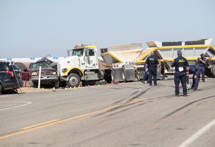 Investigators work the scene of a two vehicle crash that killed at least 13 people on Highway 115 near Holtville, Ca., March 2, 2021.