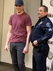 Gilbert police Officer David Bush is reunited with Ethan Wright, 18, on Feb. 25, 2021, at his retirement ceremony. Bush saved Wright 15 years ago.